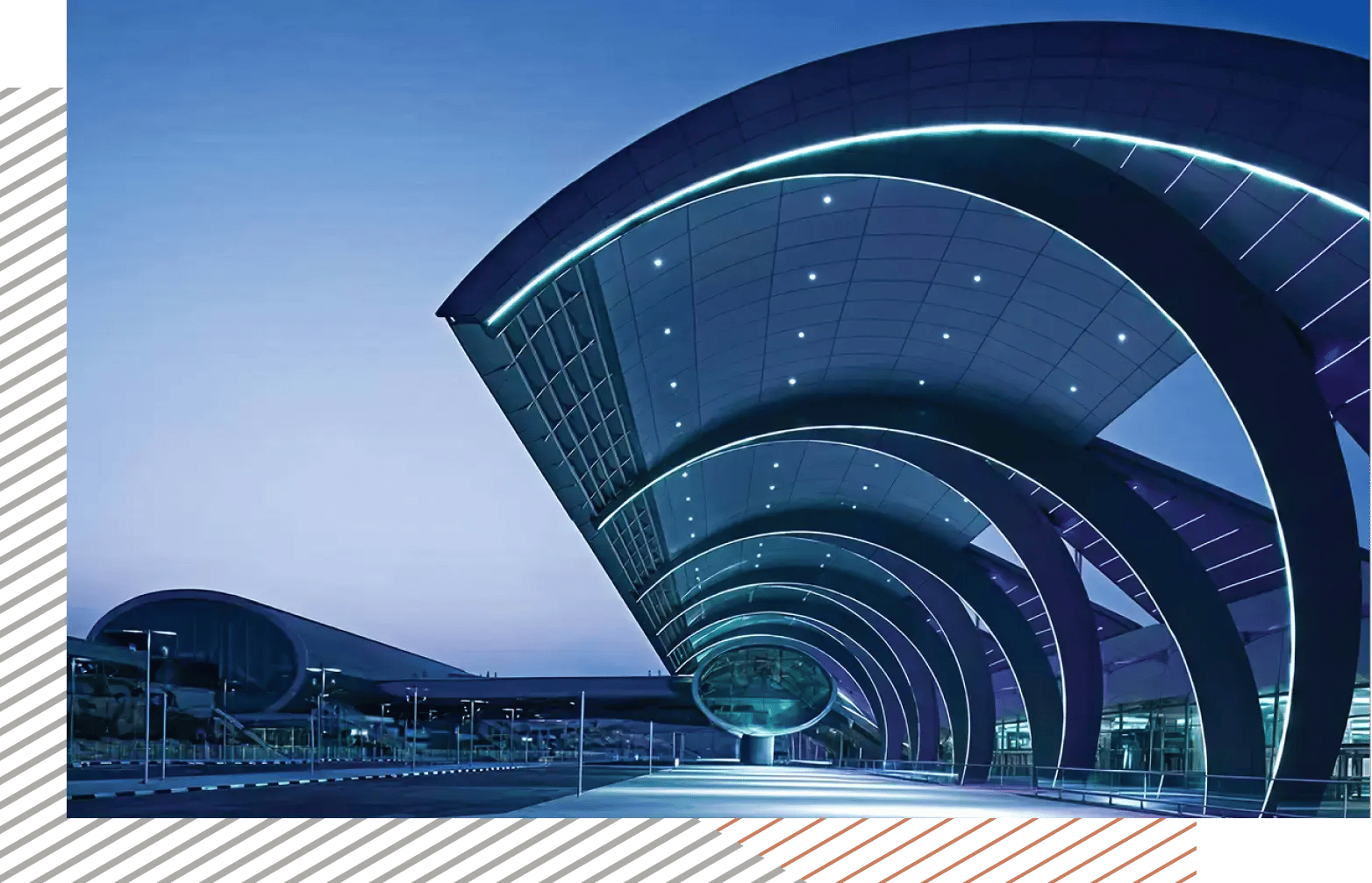 Modern airport terminal at night with futuristic architecture and vibrant purple lighting.
